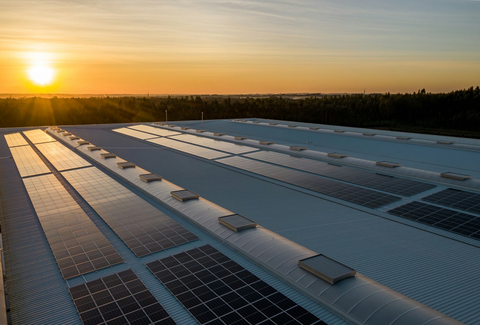Telhado de edifício comercial com módulos fotovoltaicos instalados sobre estrutura metálica